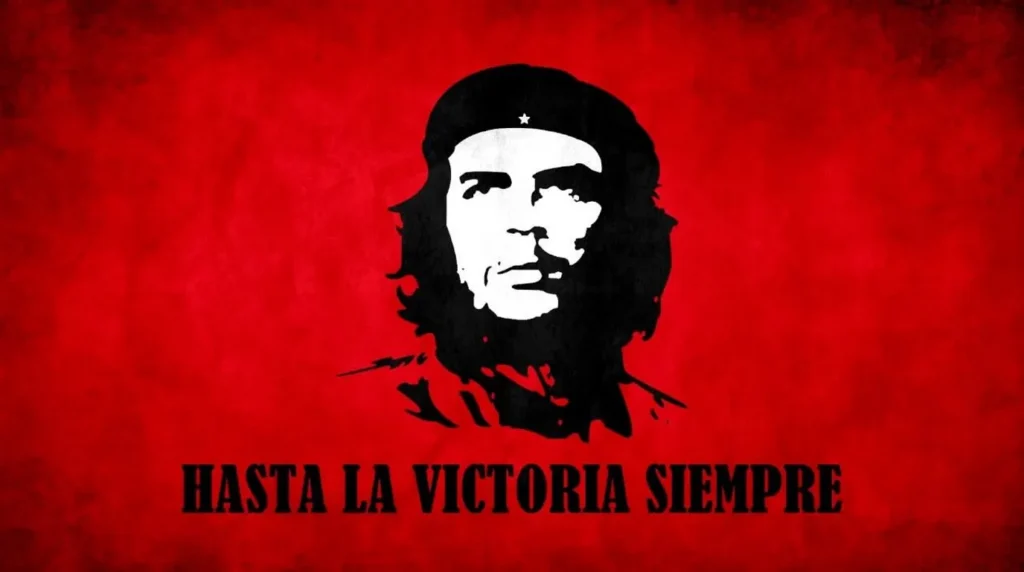 Foto hitam putih ikonik Che Guevara berlatar belakang merah bertuliskan Hasta La Victoria Siempre.