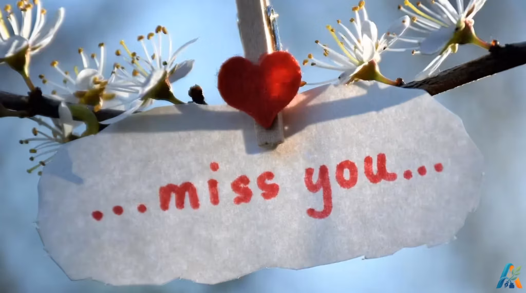 Secarik kertas bertuliskan miss you yang dijepit pada ranting bunga mekar untuk ilustrasi puisi duhai juwita