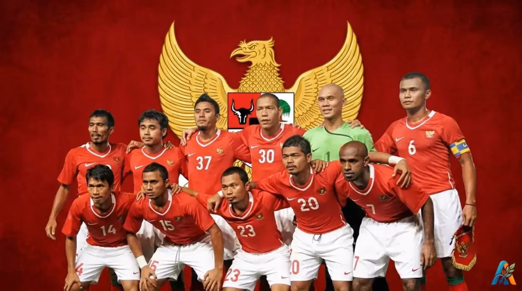Foto timnas sepak bola Indonesia dengan seragam merah putih berlatar belakang lambang negara Garuda Pancasila untuk semangat nasionalisme.