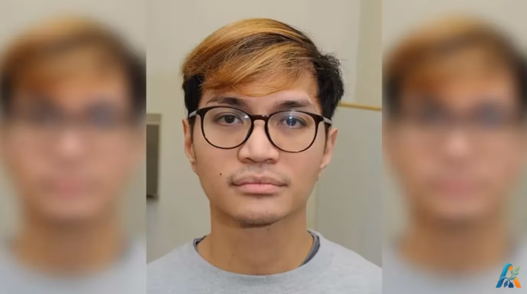 Potret wajah Reynhard Sinaga dengan rambut berpotongan pendek berwarna cokelat dan mengenakan kacamata berbingkai hitam.