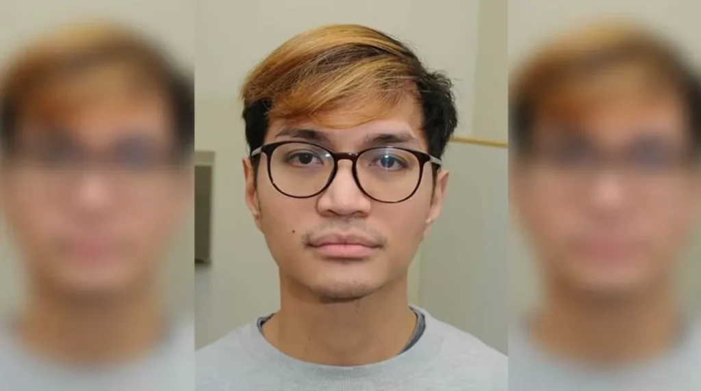 Potret wajah Reynhard Sinaga dengan rambut berpotongan pendek berwarna cokelat dan mengenakan kacamata berbingkai hitam.