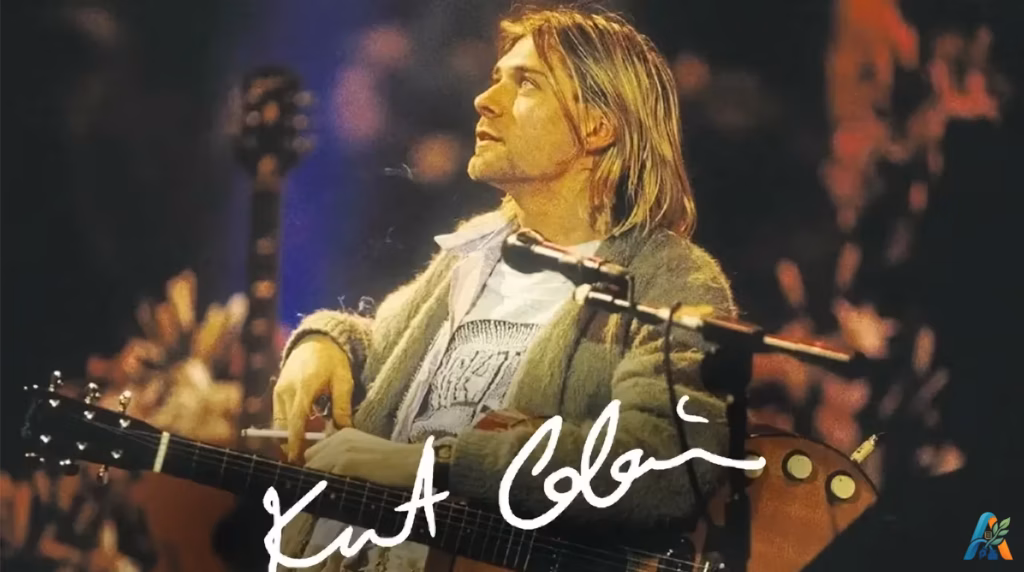 Kurt Cobain memangku gitar akustik dengan tanda tangan putih pada penampilan MTV Unplugged
